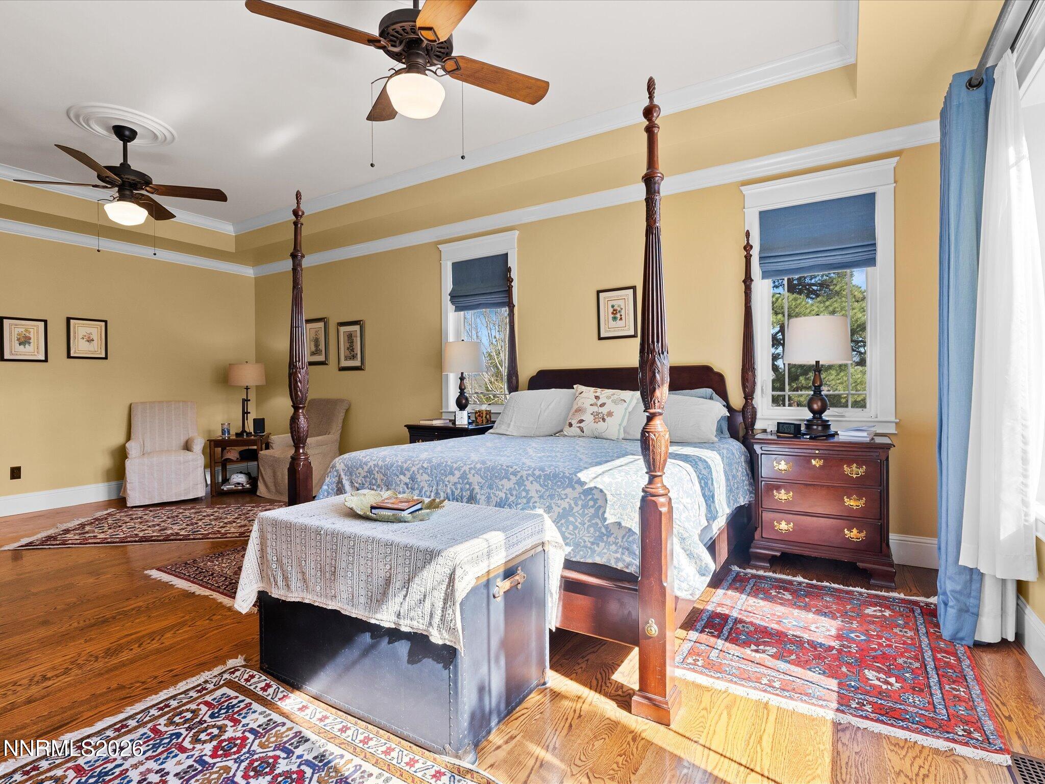201 South Argyle Court Reno, NV 89511 - Photo 32 of 95 a bedroom with a bed ceiling fan and a wooden floor