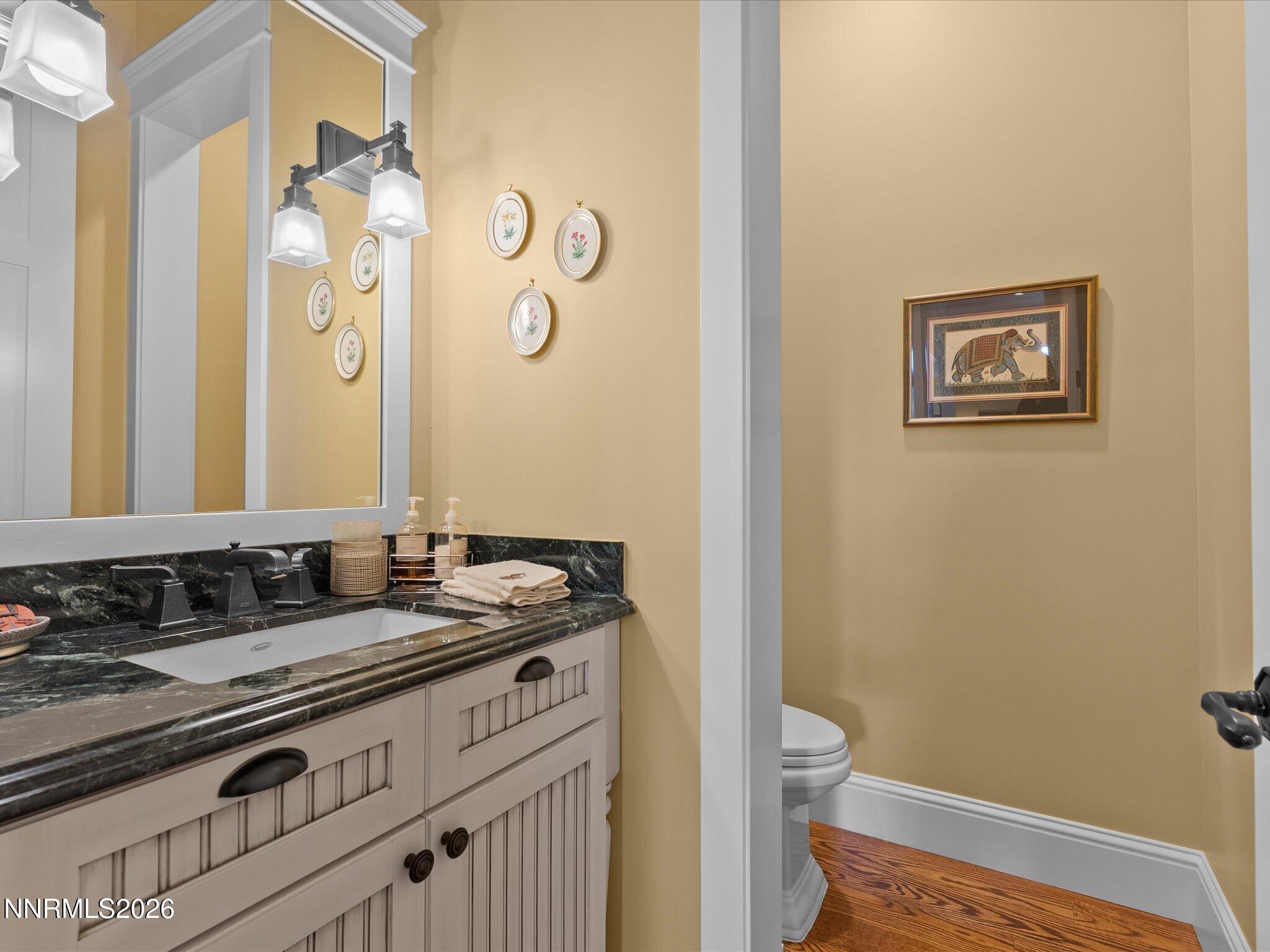 201 South Argyle Court Reno, NV 89511 - Photo 43 of 95 a bathroom with a granite countertop sink mirror vanity and a toilet