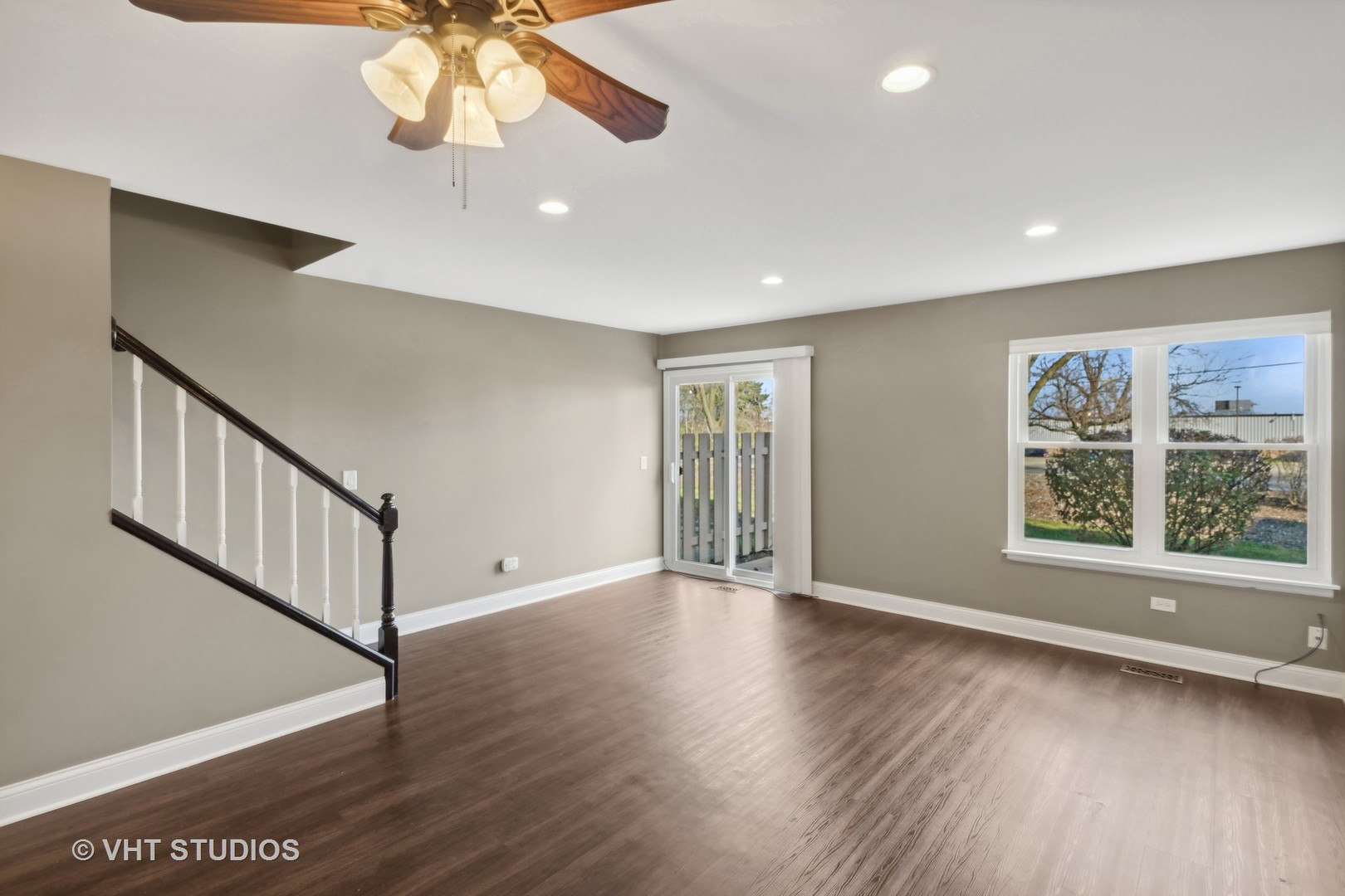 909 Ridgefield Lane Wheeling, IL 60090 - Photo 5 of 20 a view of an empty room with wooden floor and a window