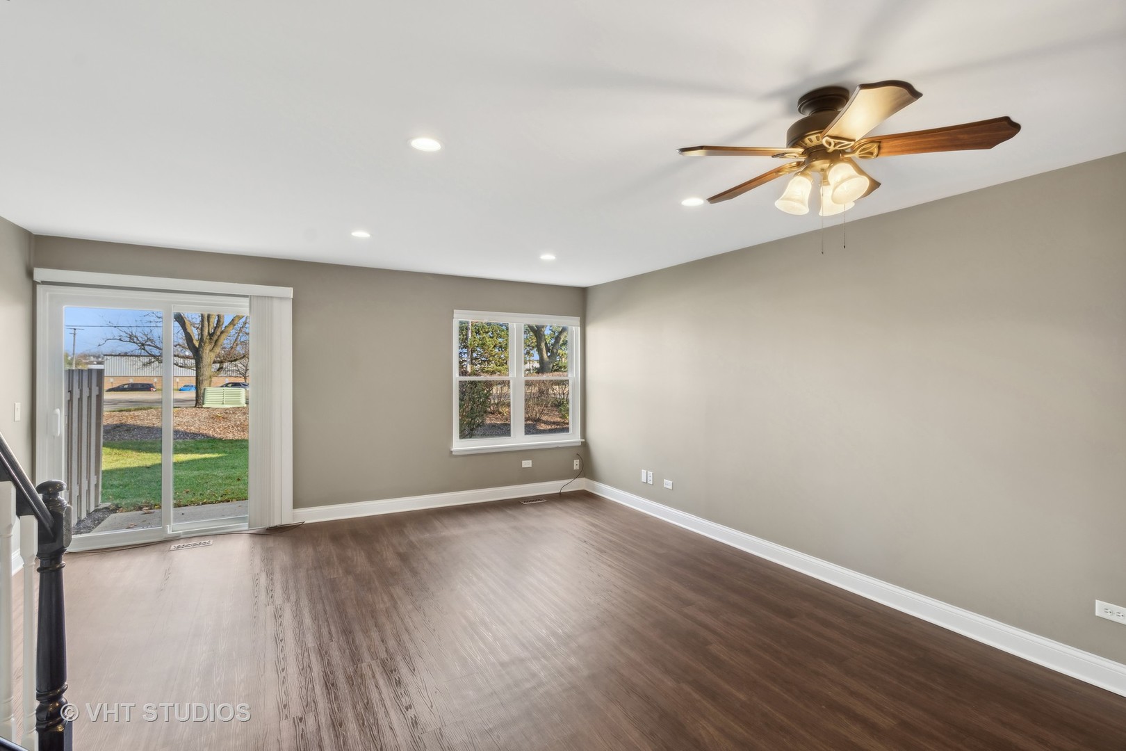 909 Ridgefield Lane Wheeling, IL 60090 - Photo 6 of 20 a view of an empty room with wooden floor and a window