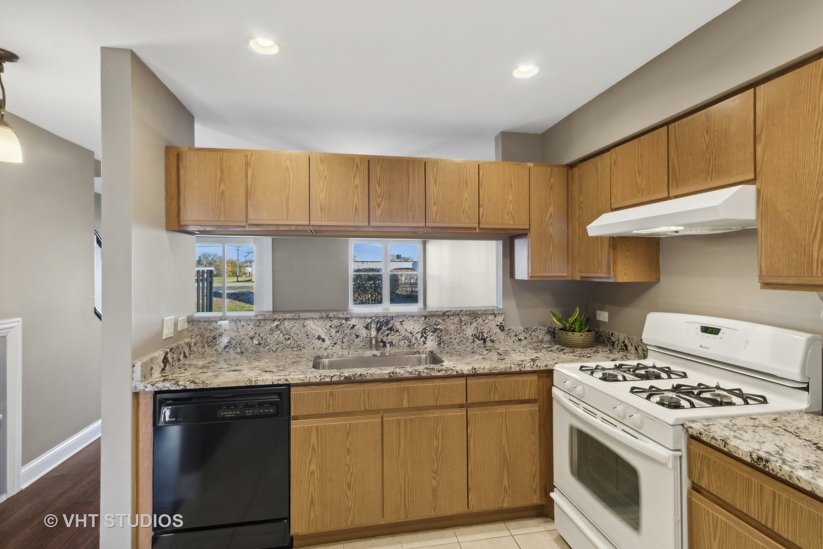 909 Ridgefield Lane Wheeling, IL 60090 - Photo 10 of 20 a kitchen with stainless steel appliances granite countertop a sink stove and refrigerator
