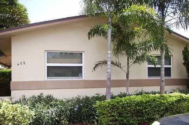 a front view of a house with yard and garage