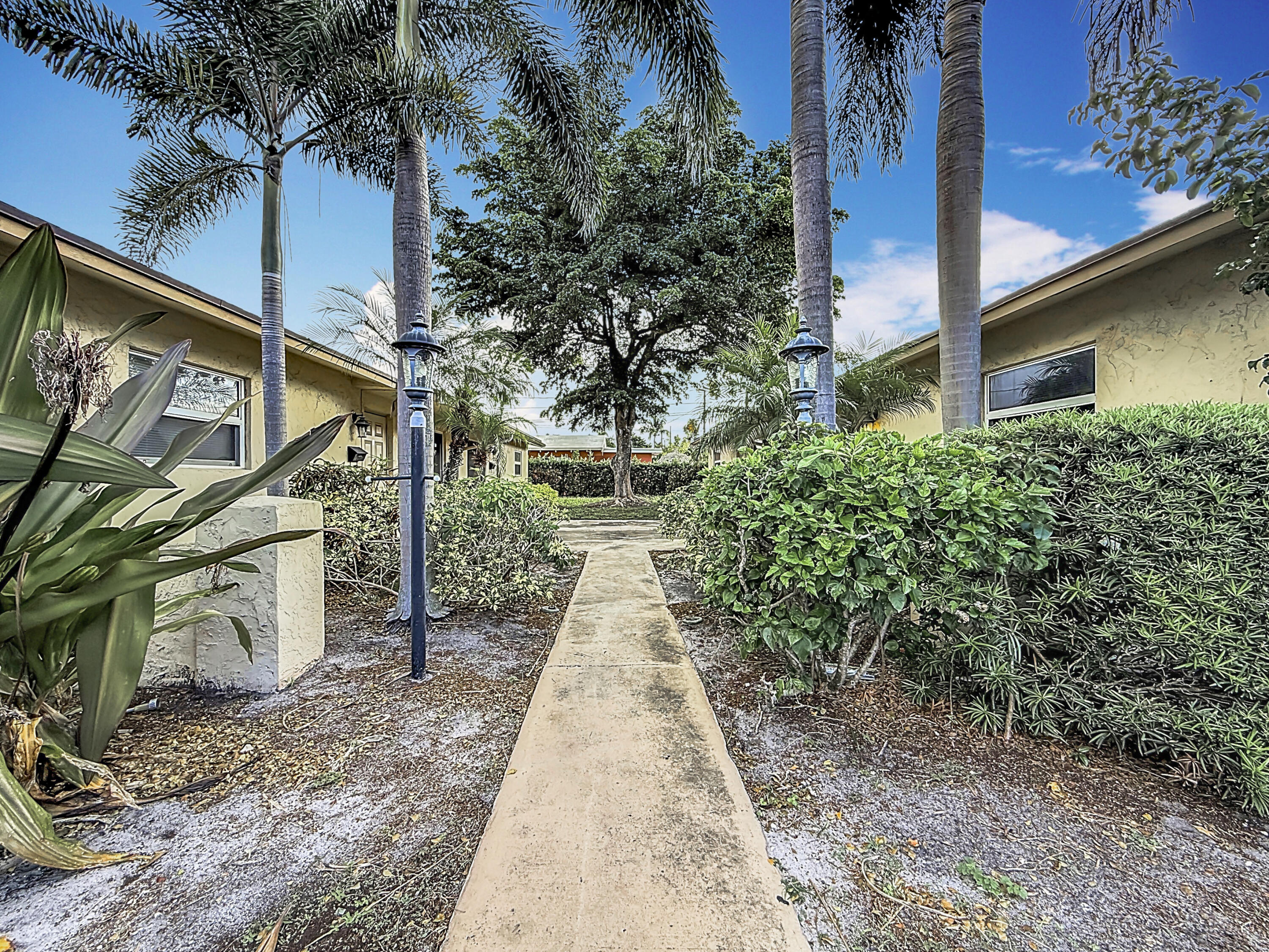 408 Northeast 12th Avenue, Unit 2 Pompano Beach, FL 33060 - Photo 12 of 14 a view of a pathway of a house with a yard