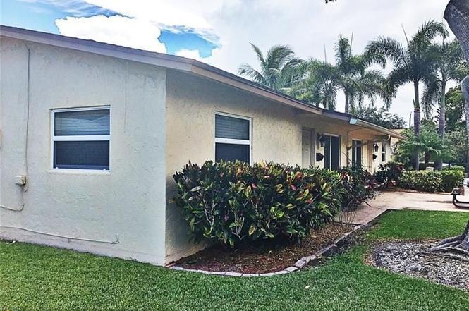 408 Northeast 12th Avenue, Unit 2 Pompano Beach, FL 33060 - Photo 3 of 14 a view of a house with a yard and potted plants