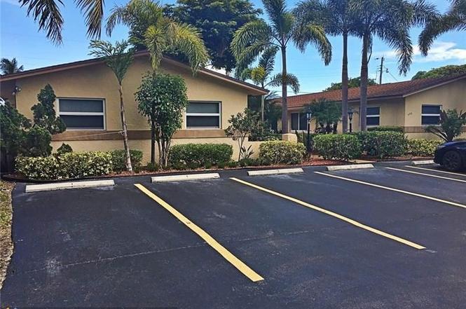 408 Northeast 12th Avenue, Unit 2 Pompano Beach, FL 33060 - Photo 5 of 14 a front view of a house with yard and parking