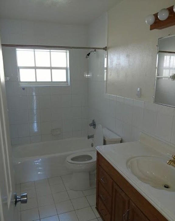 408 Northeast 12th Avenue, Unit 2 Pompano Beach, FL 33060 - Photo 7 of 14 a bathroom with a sink a toilet and shower