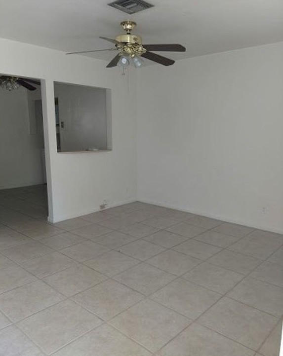 408 Northeast 12th Avenue, Unit 2 Pompano Beach, FL 33060 - Photo 9 of 14 a view of an empty room with a fan