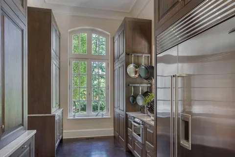 a kitchen with stainless steel appliances a refrigerator and a window