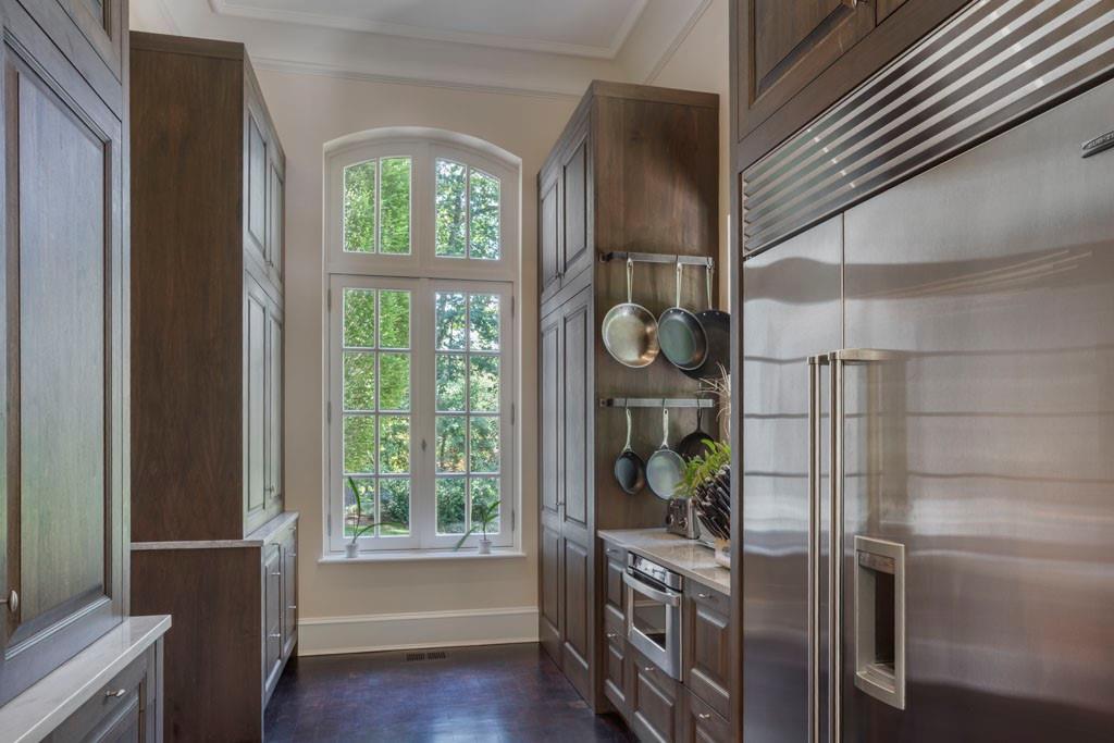 133 Blackland Road Northwest Atlanta, GA 30342 - Photo 12 of 38 a kitchen with stainless steel appliances a refrigerator and a window