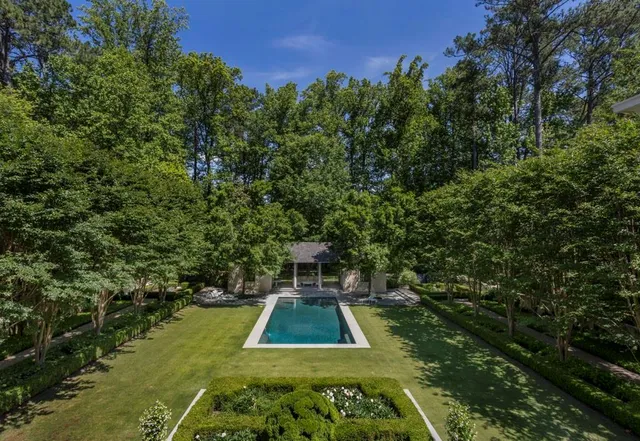 a view of a swimming pool with a yard