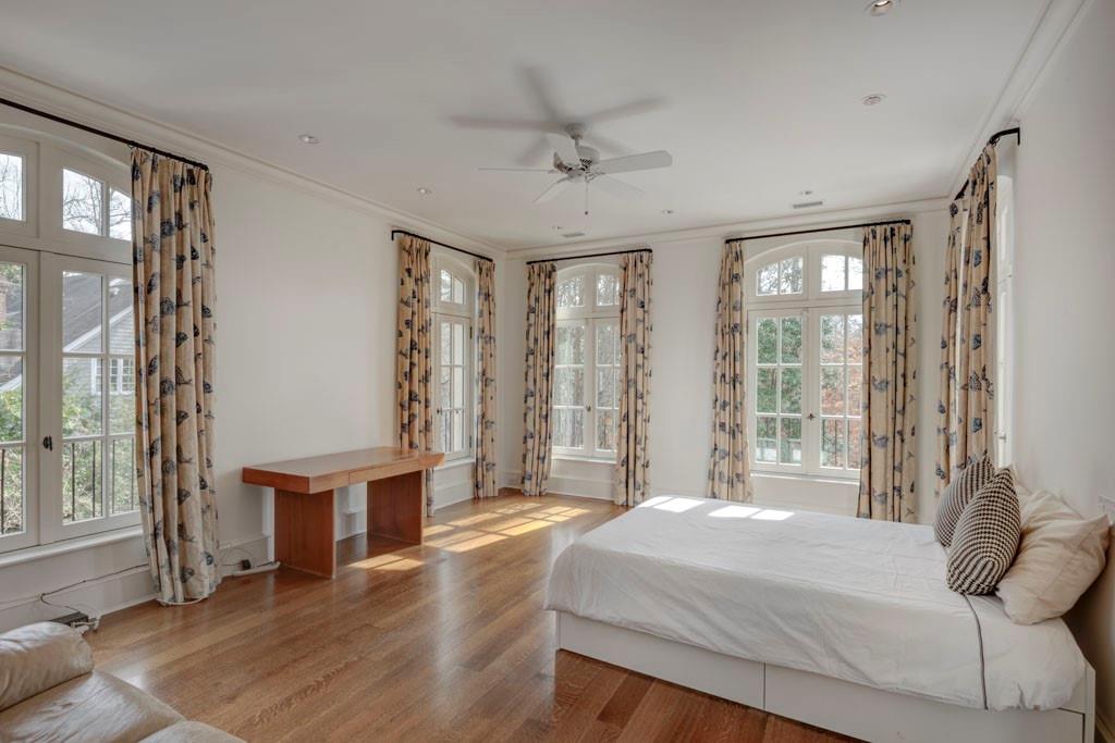 133 Blackland Road Northwest Atlanta, GA 30342 - Photo 27 of 38 a bedroom with a bed and large windows with curtains