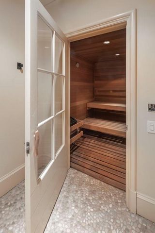 a view of a closet area with wooden floor