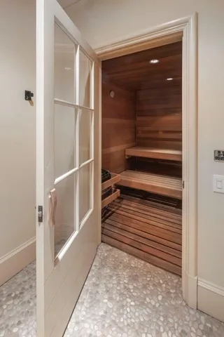 a view of a closet area with wooden floor
