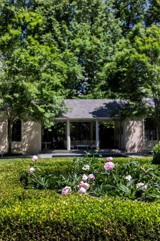 a view of a house with a flower garden
