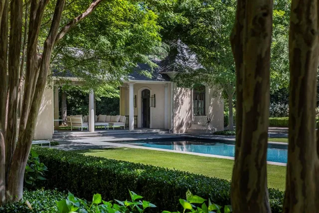 a view of a house with swimming pool and garden