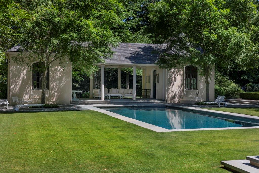 133 Blackland Road Northwest Atlanta, GA 30342 - Photo 5 of 38 a view of a swimming pool and a table and chairs in patio
