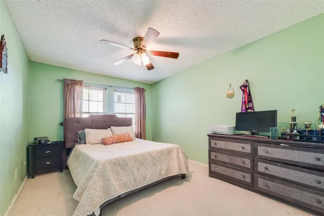 a bedroom with bed and a chandelier