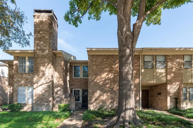 a view of backyard with outdoor seating and plants