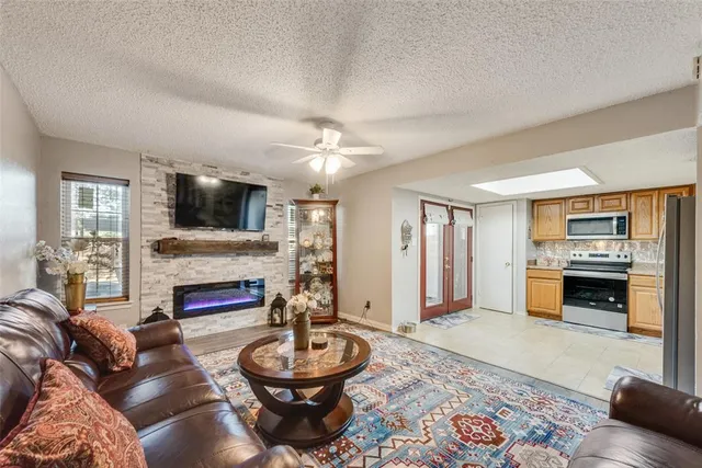 a living room with furniture a fireplace and a flat screen tv