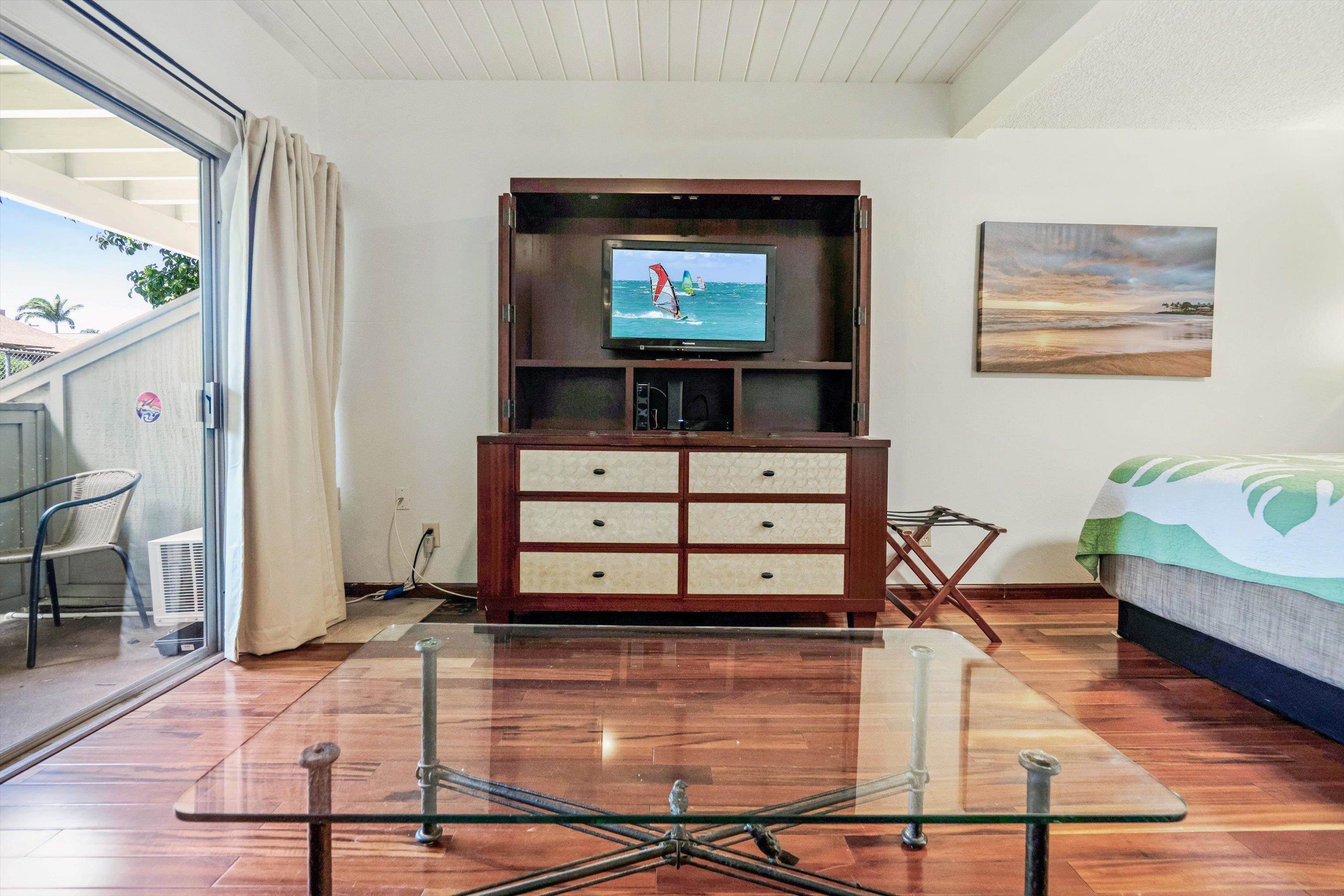715 South Kihei Road, Unit B 120 Kihei, HI 96753 - Photo 14 of 36 a living room with furniture a flat screen tv and a table