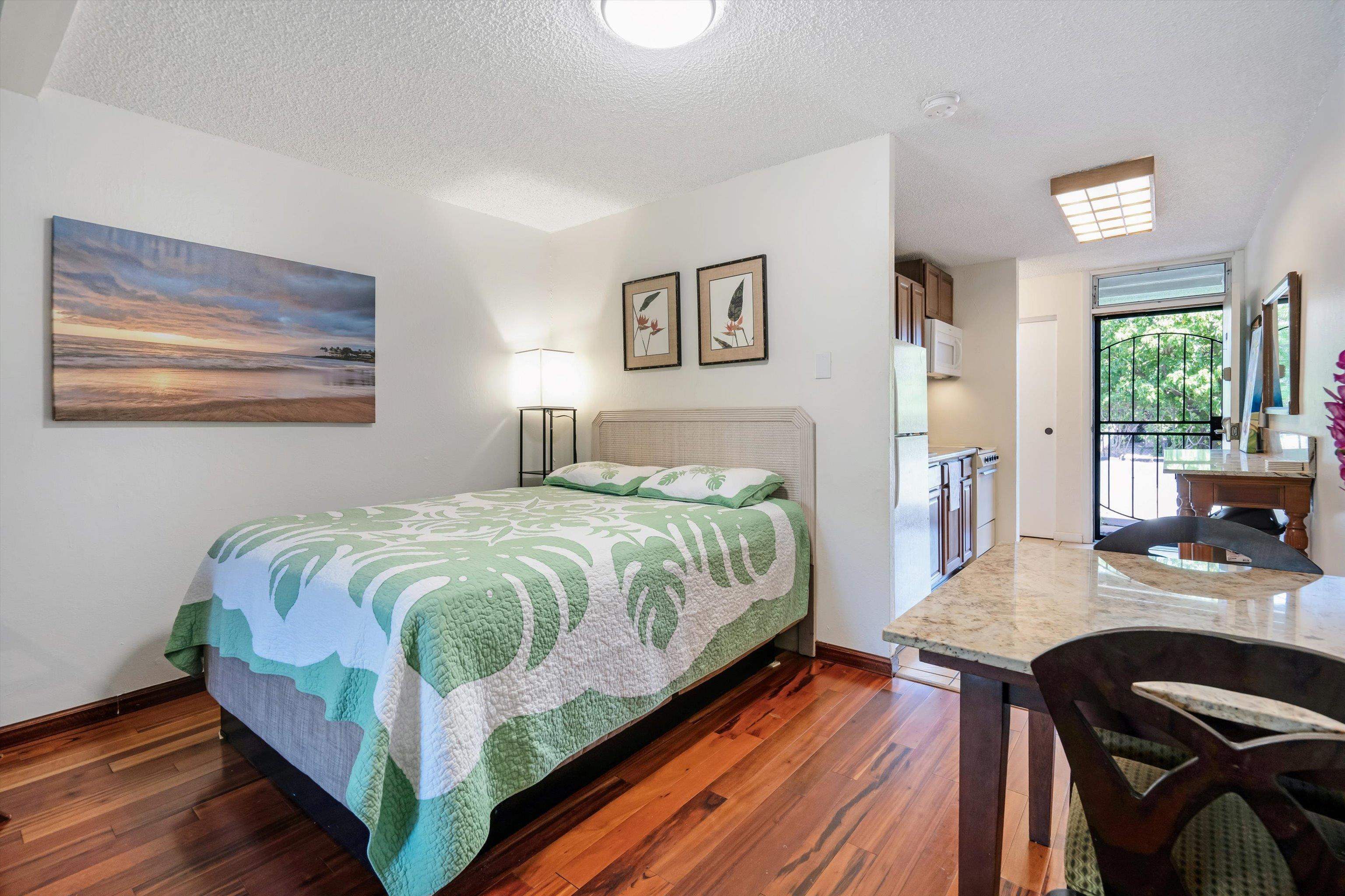 715 South Kihei Road, Unit B 120 Kihei, HI 96753 - Photo 15 of 36 a bedroom with a bed and a table