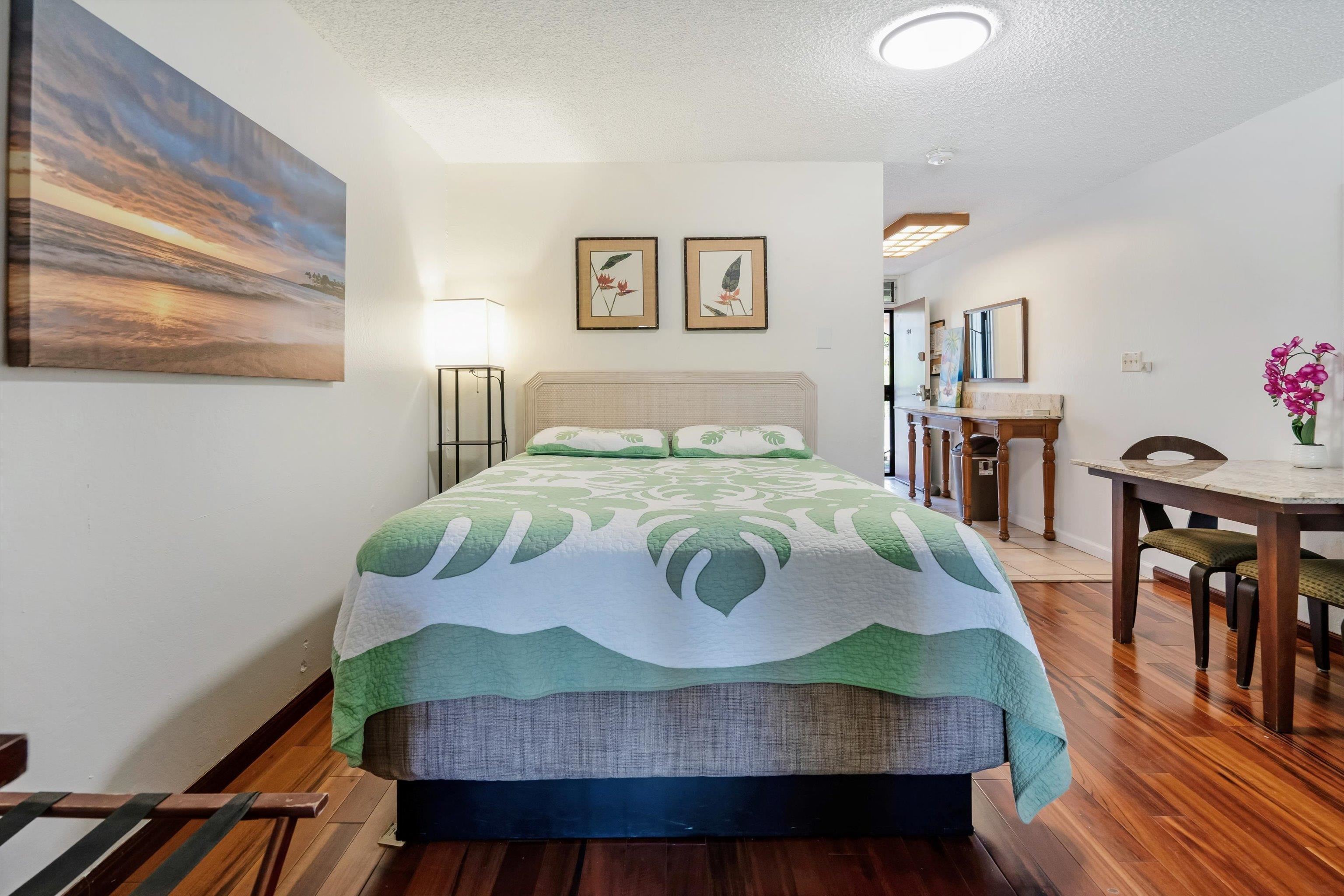 715 South Kihei Road, Unit B 120 Kihei, HI 96753 - Photo 16 of 36 a bedroom with a bed a dresser and wooden floor