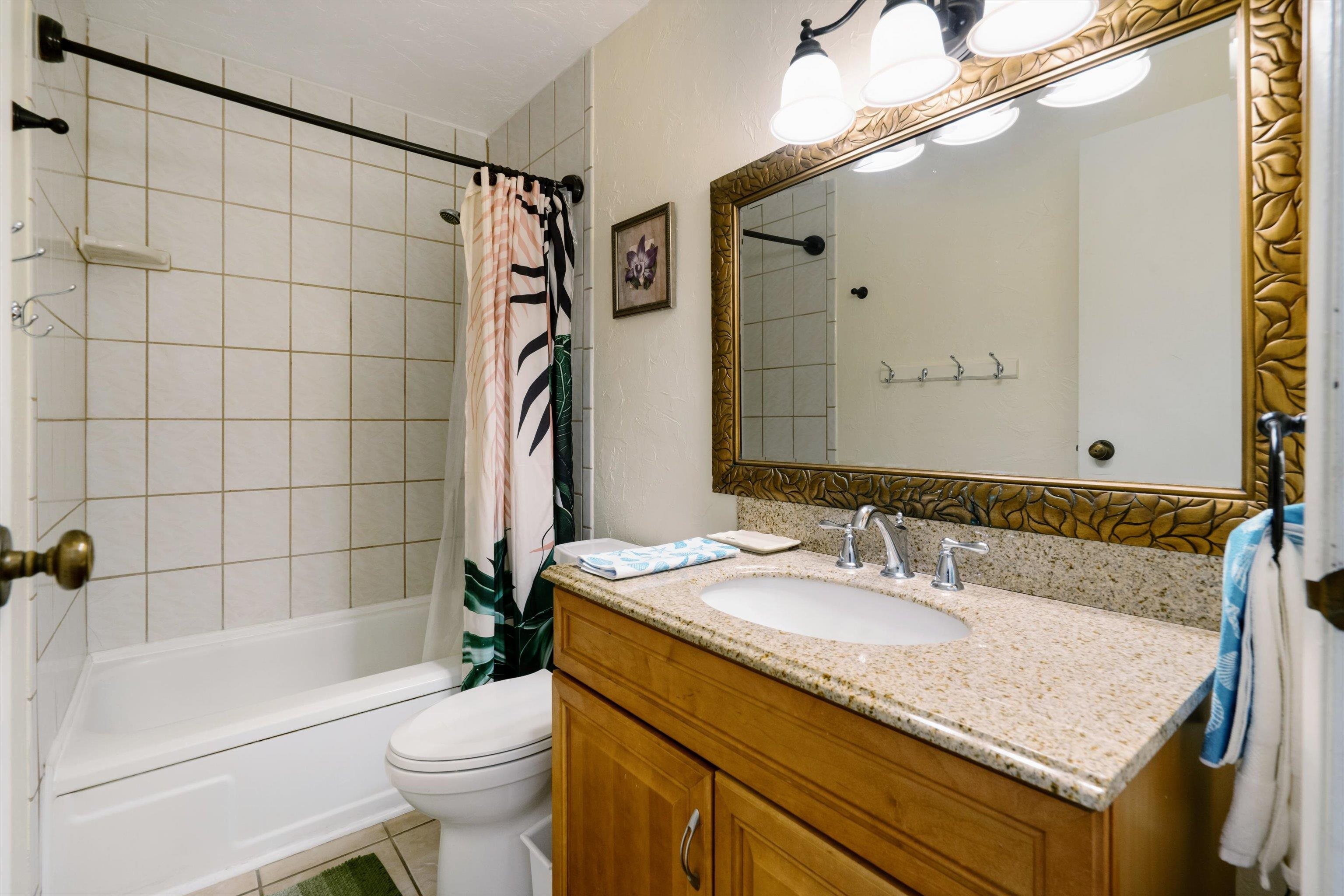 715 South Kihei Road, Unit B 120 Kihei, HI 96753 - Photo 18 of 36 a bathroom with a granite countertop sink a toilet a mirror and shower