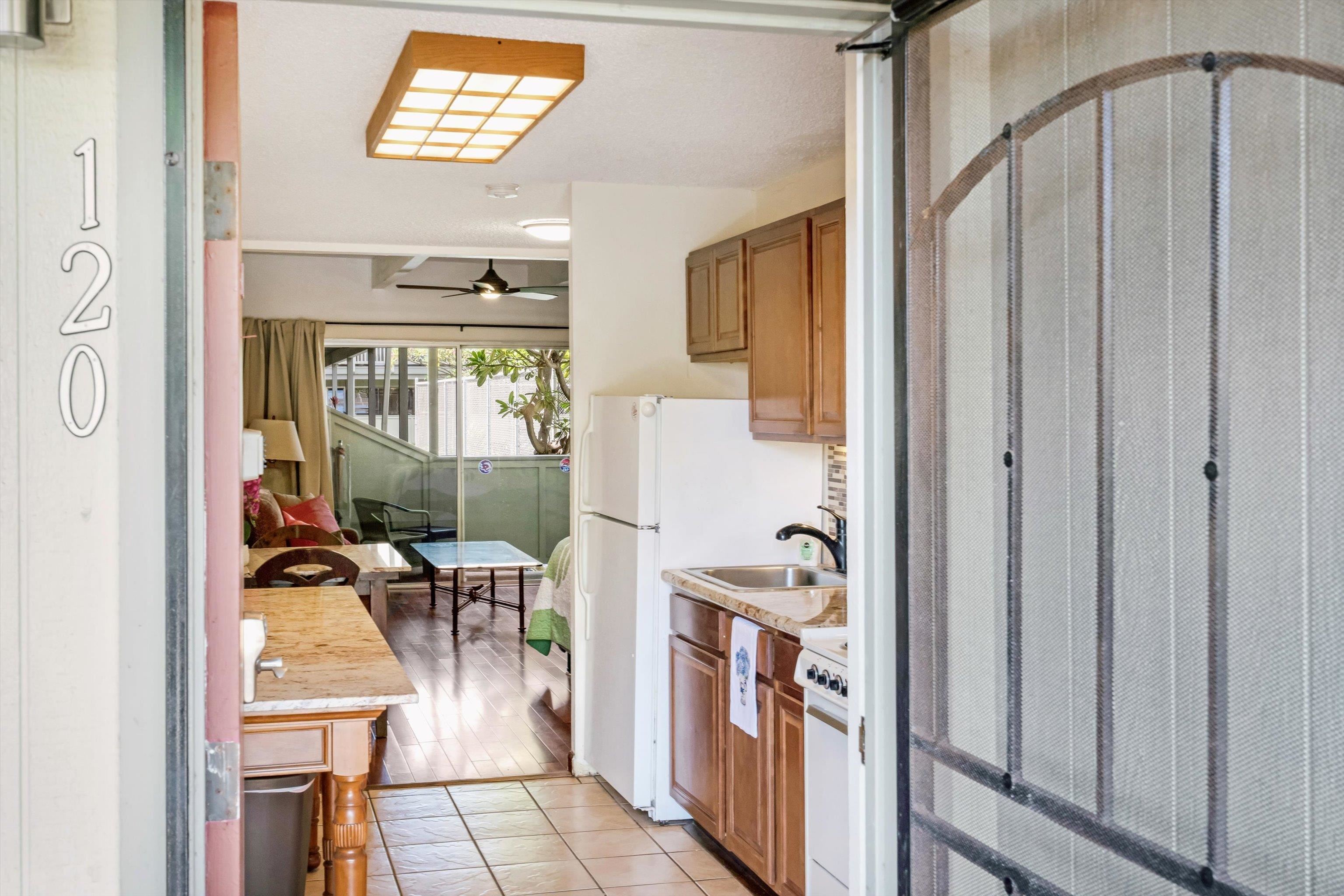 715 South Kihei Road, Unit B 120 Kihei, HI 96753 - Photo 2 of 36 a view of a hallway with living room and dining table