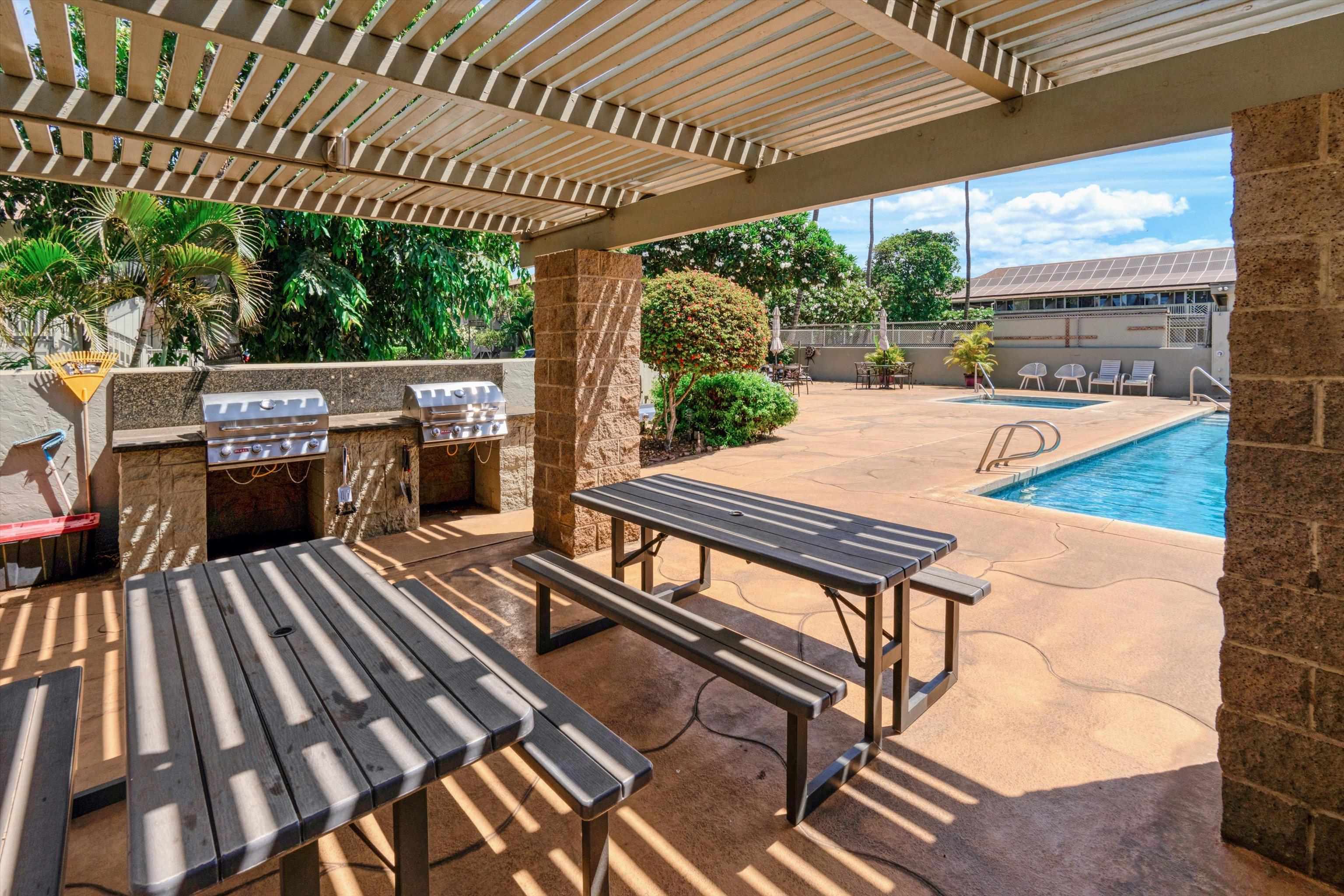 715 South Kihei Road, Unit B 120 Kihei, HI 96753 - Photo 26 of 36 a view of a patio with table and chairs with wooden floor and outdoor seating