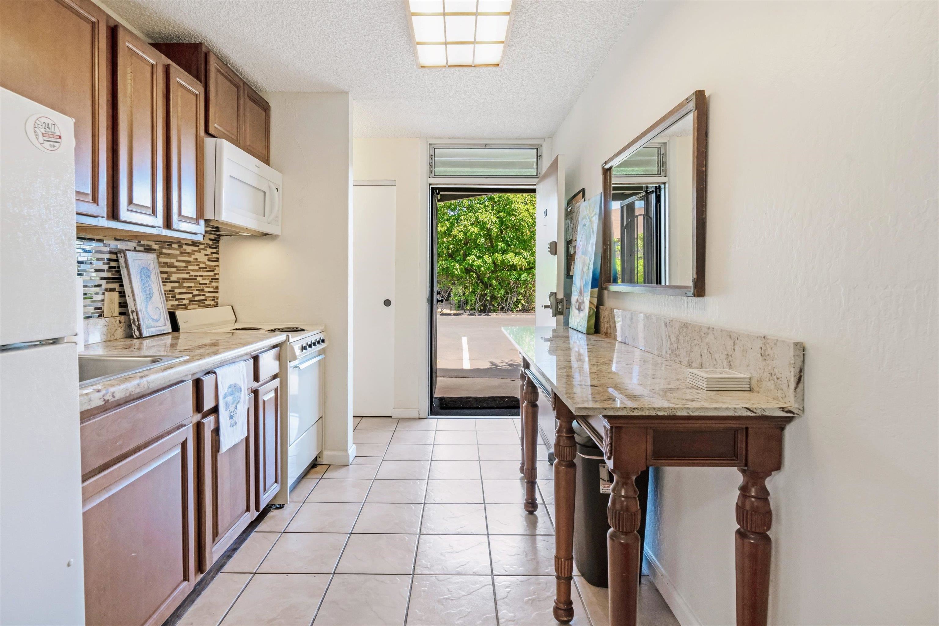 715 South Kihei Road, Unit B 120 Kihei, HI 96753 - Photo 3 of 36 a kitchen with stainless steel appliances a sink and a stove