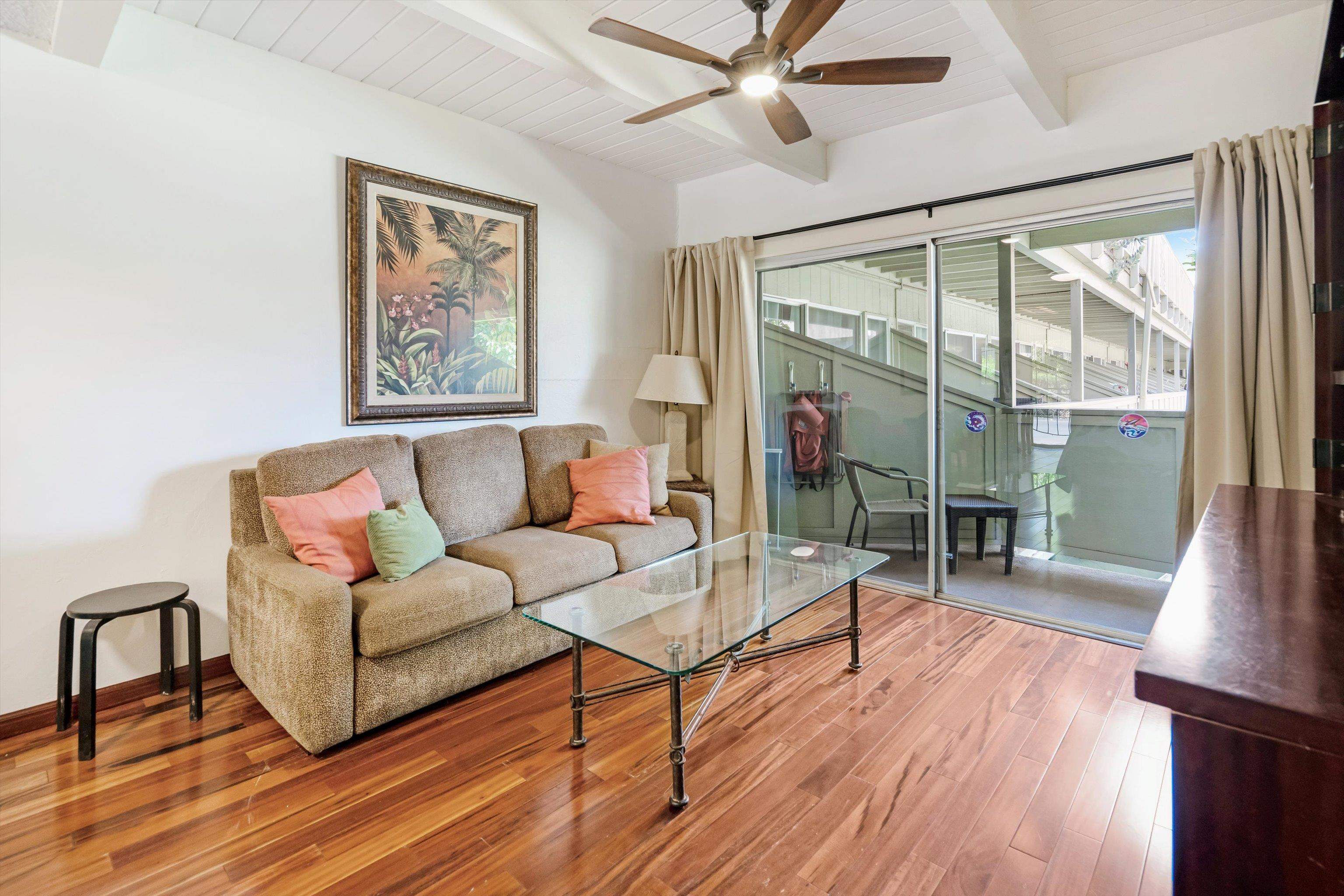 715 South Kihei Road, Unit B 120 Kihei, HI 96753 - Photo 6 of 36 a living room with wooden floor and a table