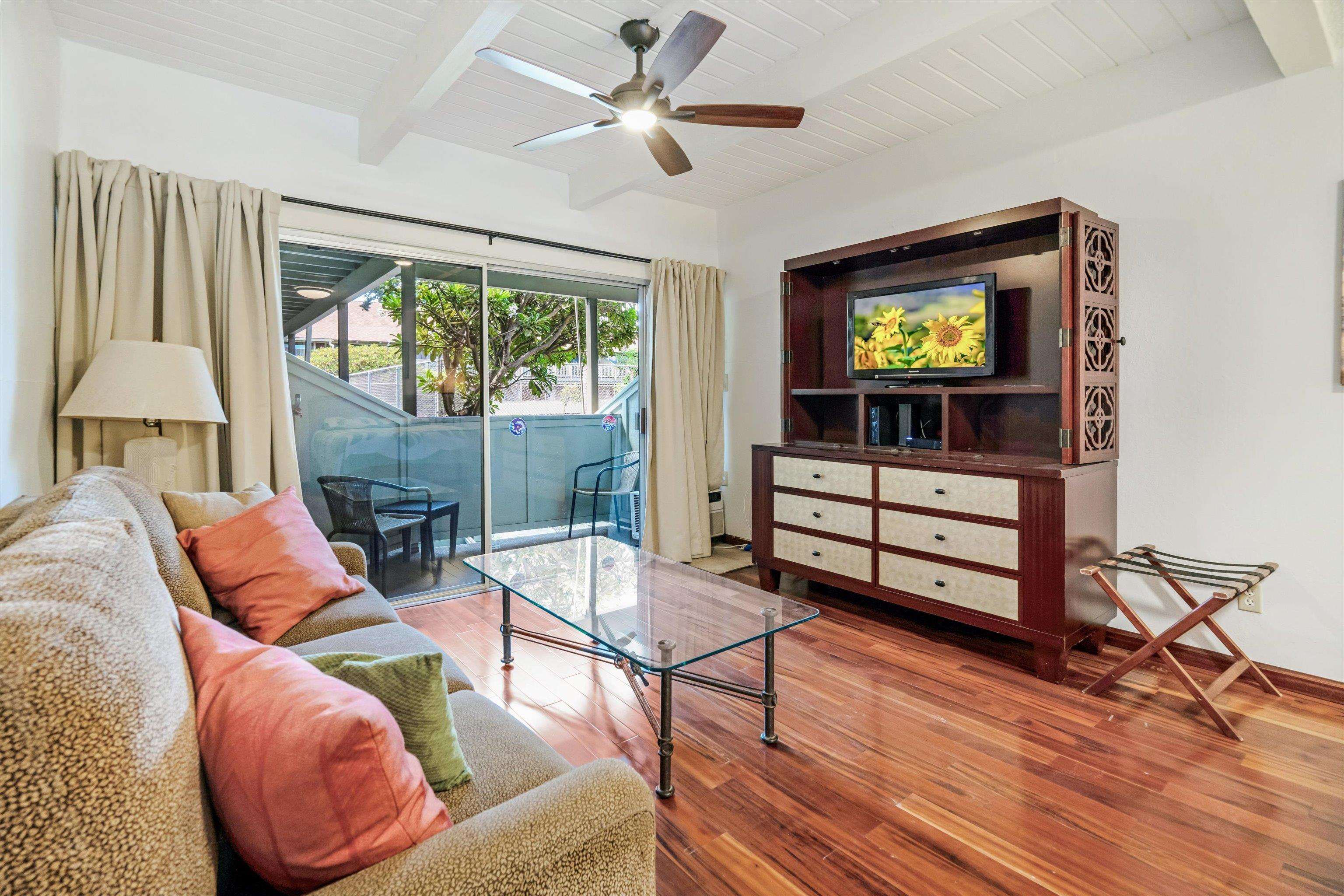715 South Kihei Road, Unit B 120 Kihei, HI 96753 - Photo 8 of 36 a living room with furniture a window and a flat screen tv