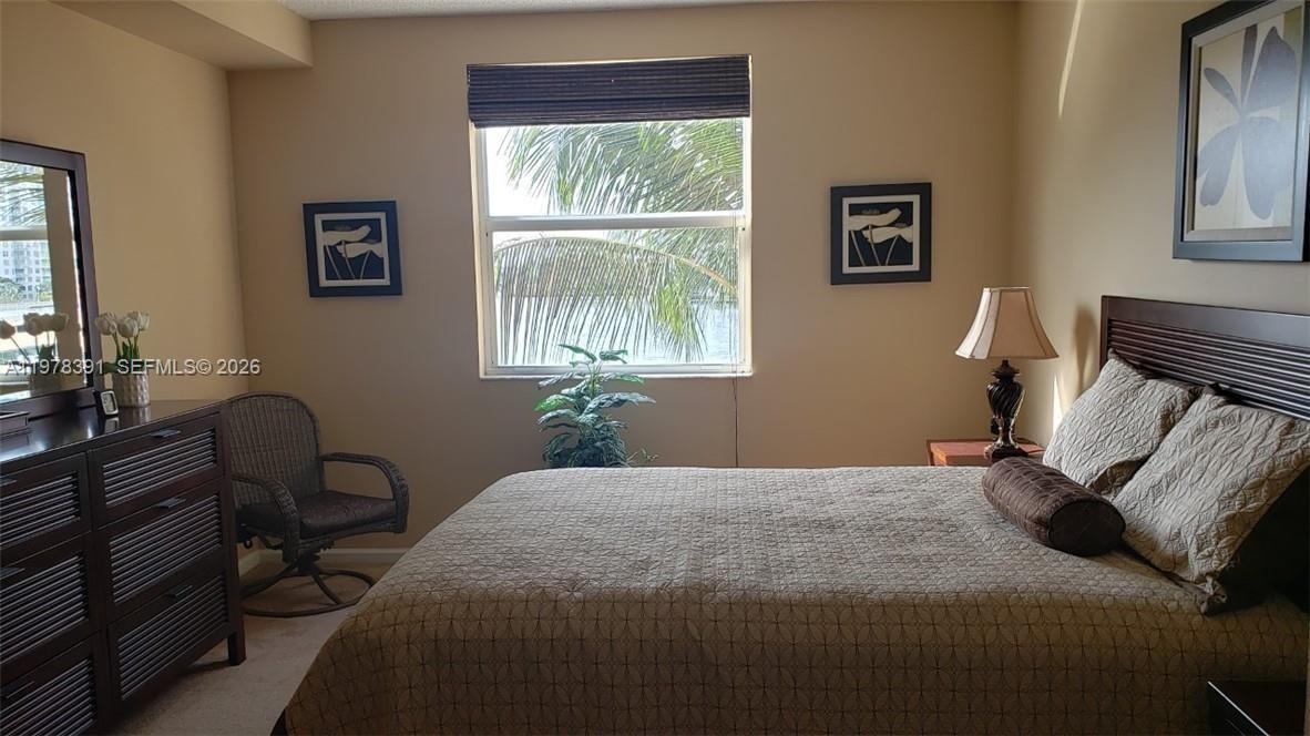 17150 North Bay Road, Unit 2406 Sunny Isles Beach, FL 33160 - Photo 13 of 22 a bedroom with a bed and wooden floor