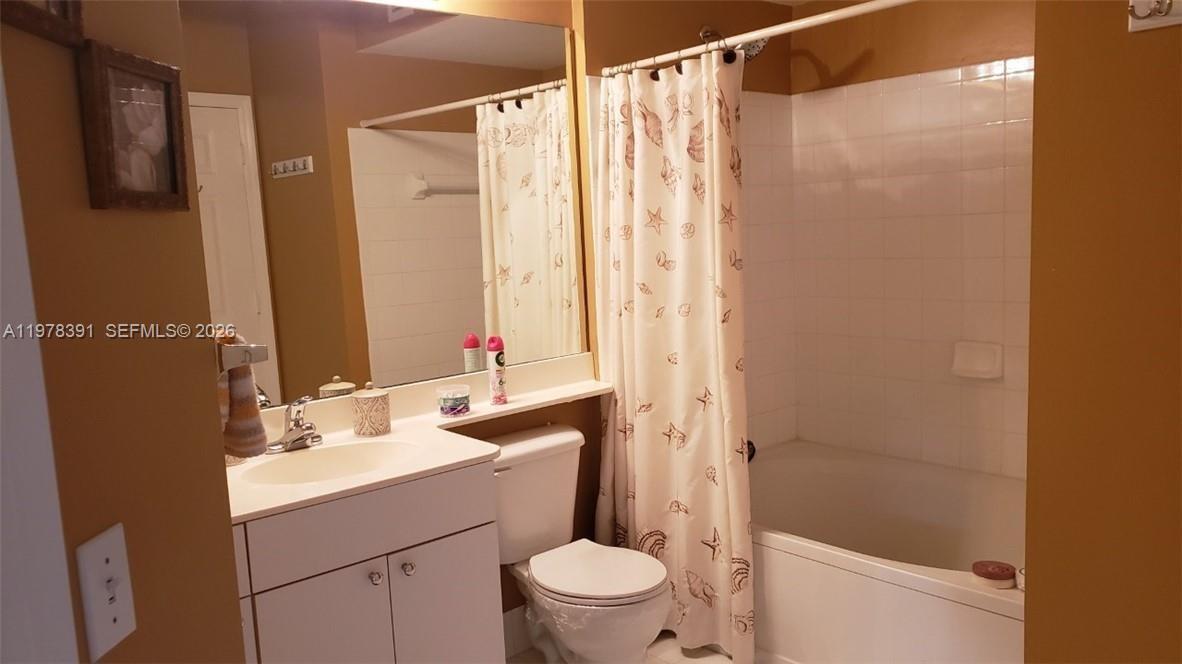 17150 North Bay Road, Unit 2406 Sunny Isles Beach, FL 33160 - Photo 14 of 22 a bathroom with a sink a toilet and shower
