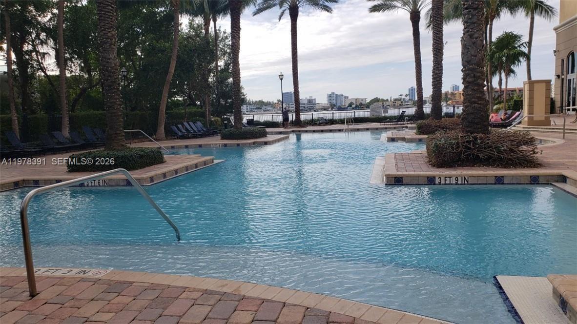 17150 North Bay Road, Unit 2406 Sunny Isles Beach, FL 33160 - Photo 21 of 22 a view of a lake with palm trees