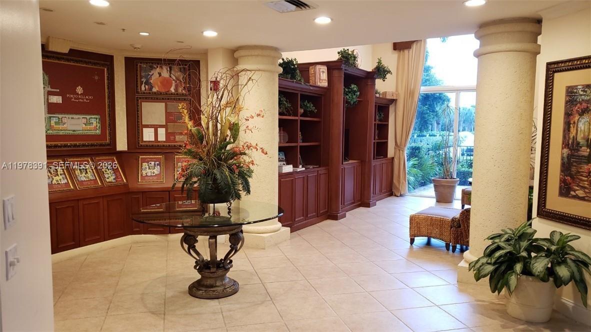 17150 North Bay Road, Unit 2406 Sunny Isles Beach, FL 33160 - Photo 22 of 22 a living room with furniture flowers and cabinets