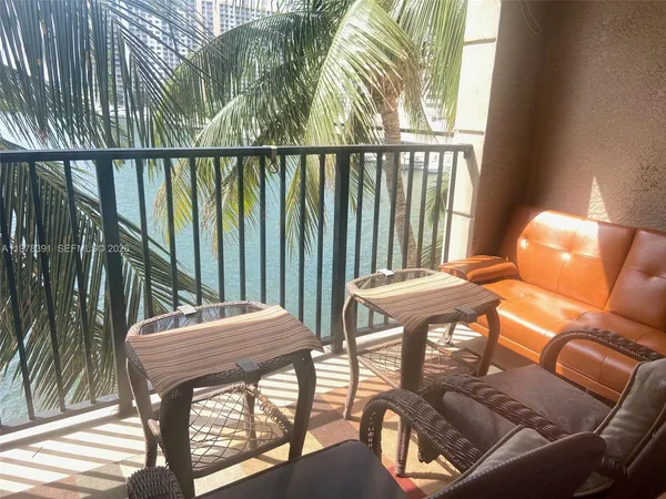 a balcony view with a seating space