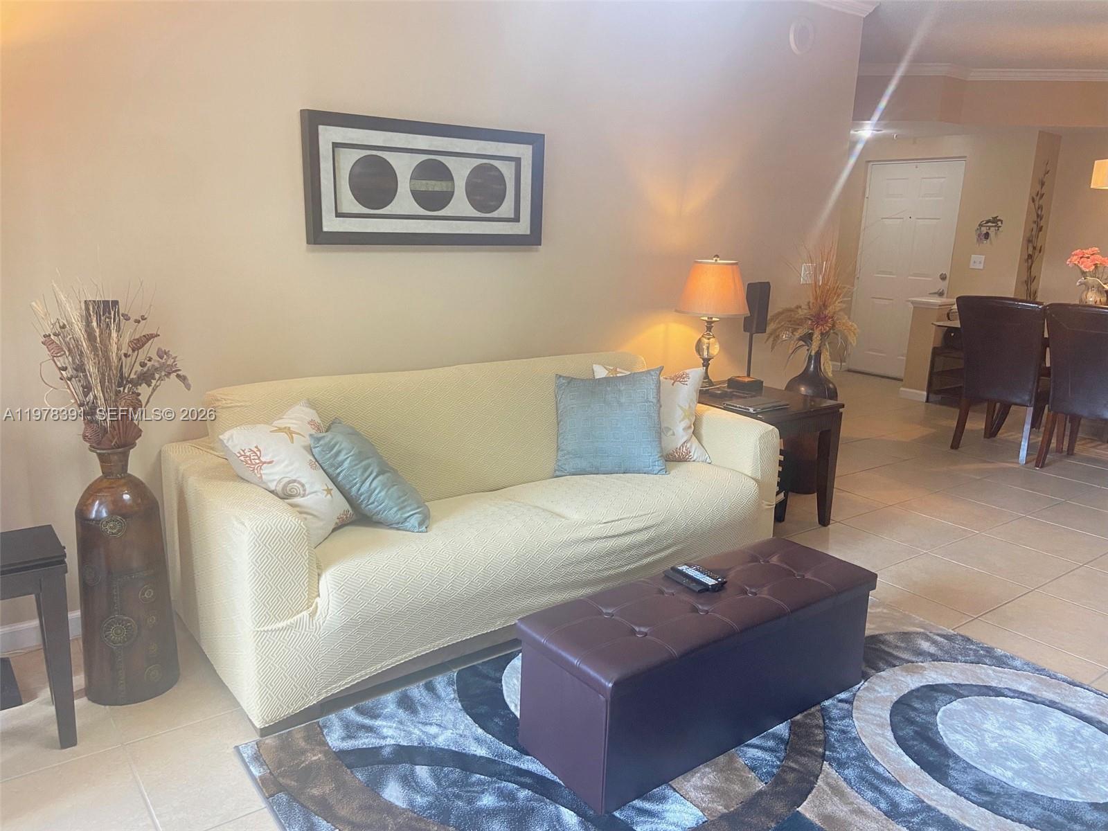 17150 North Bay Road, Unit 2406 Sunny Isles Beach, FL 33160 - Photo 4 of 22 a living room with furniture and wooden floor