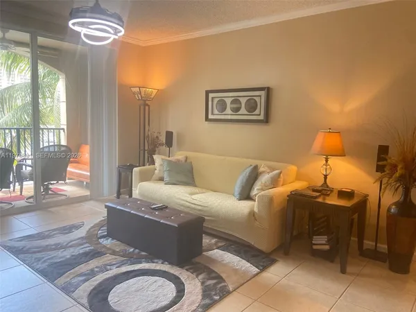 a living room with furniture a chandelier and a window