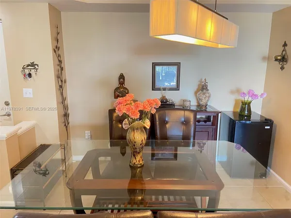 a view of dining table chairs and chandelier