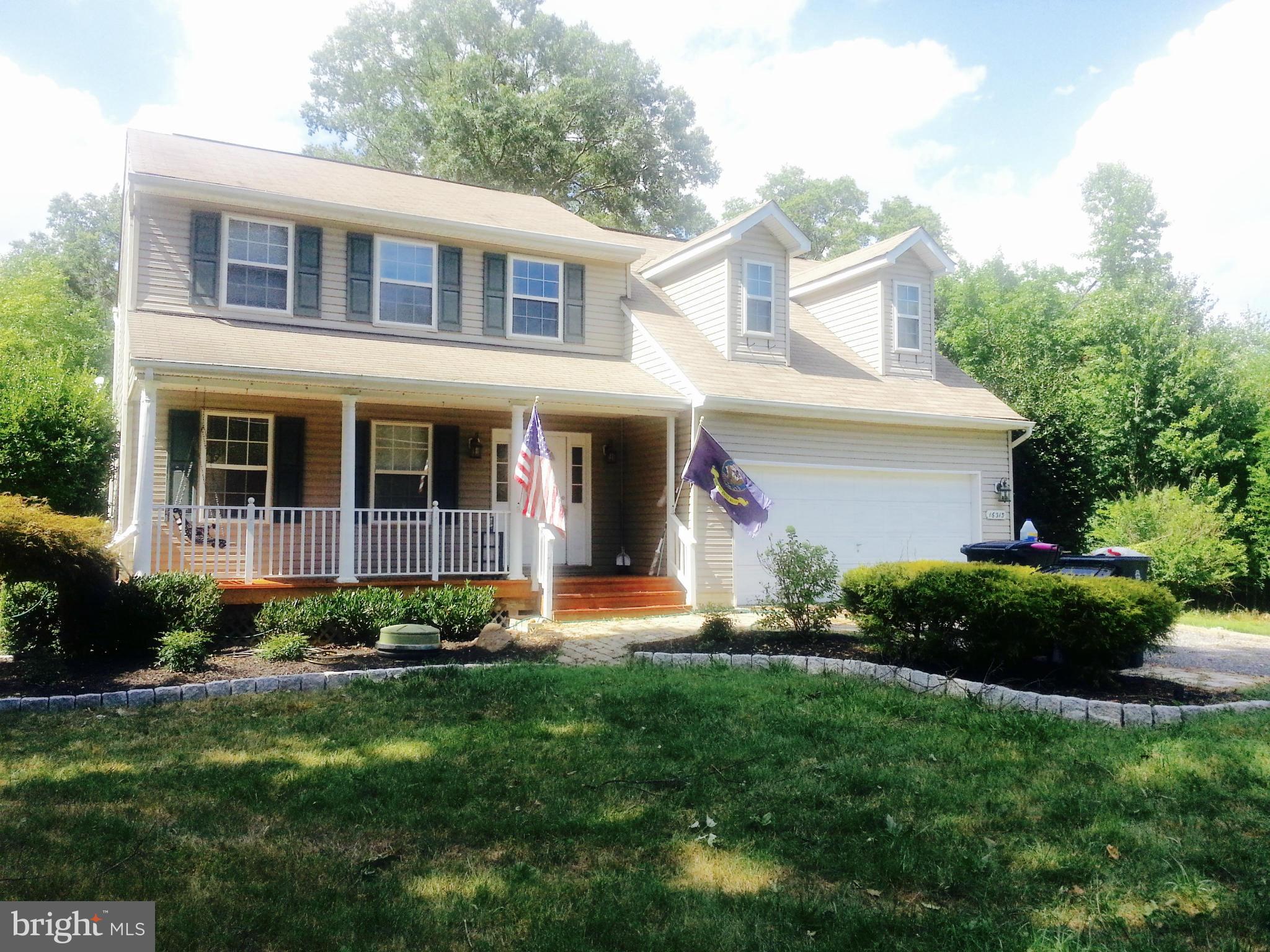 16313 Manning Road West Accokeek, MD 20607 - Photo 1 of 8 a front view of a house with a yard and potted plants