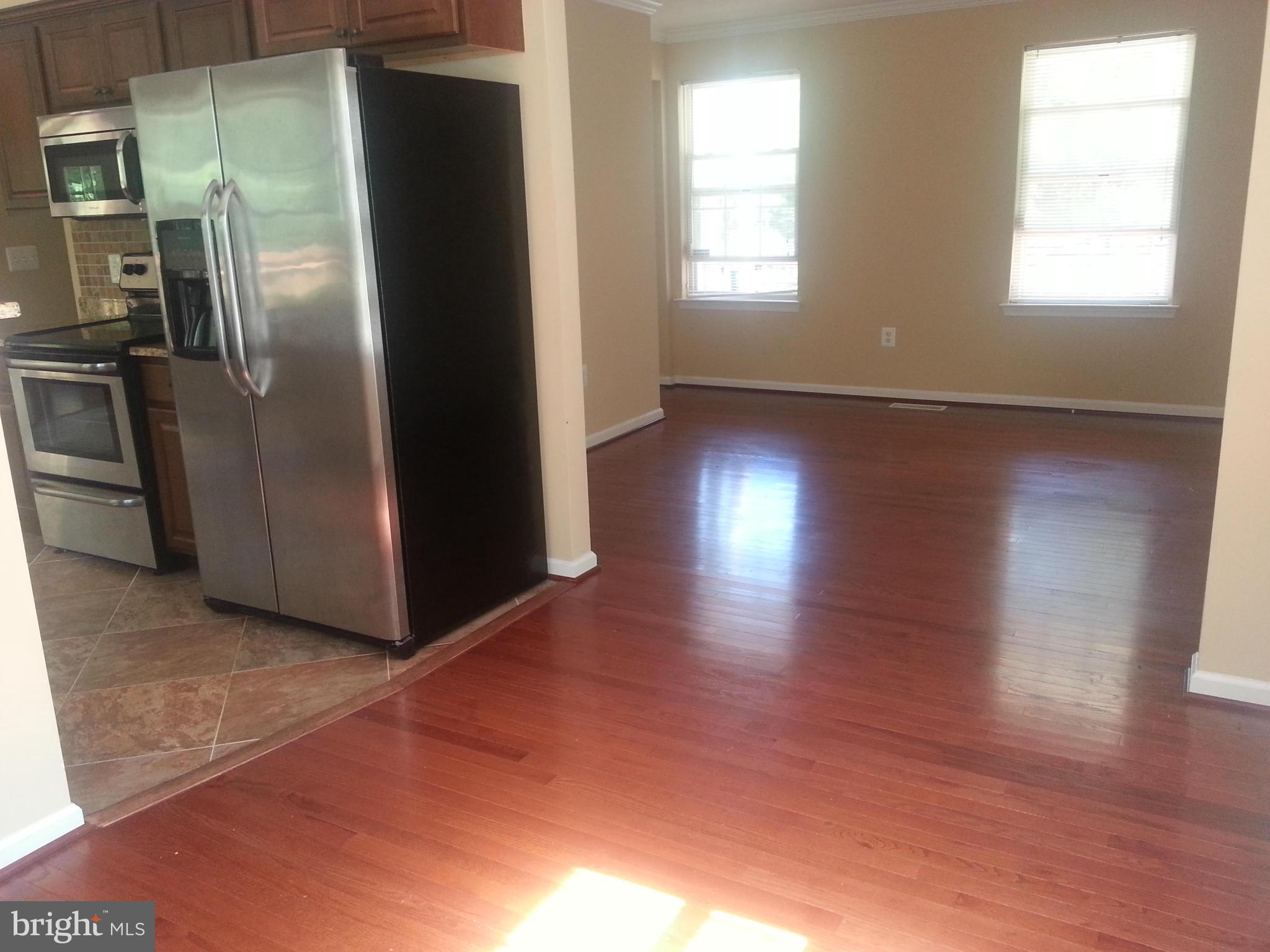16313 Manning Road West Accokeek, MD 20607 - Photo 3 of 8 a view of a refrigerator in kitchen and wooden floor