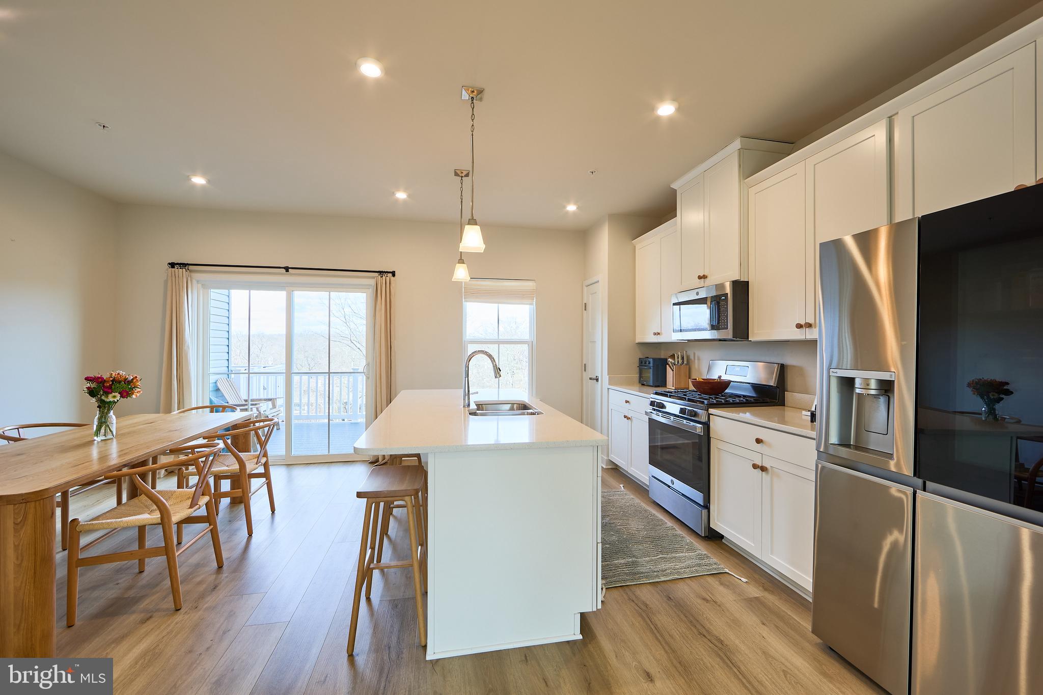 463 Paperbark Square Downingtown, PA 19335 - Photo 2 of 31 a kitchen with stainless steel appliances granite countertop a refrigerator a stove top oven a sink dishwasher and white cabinets with wooden floor