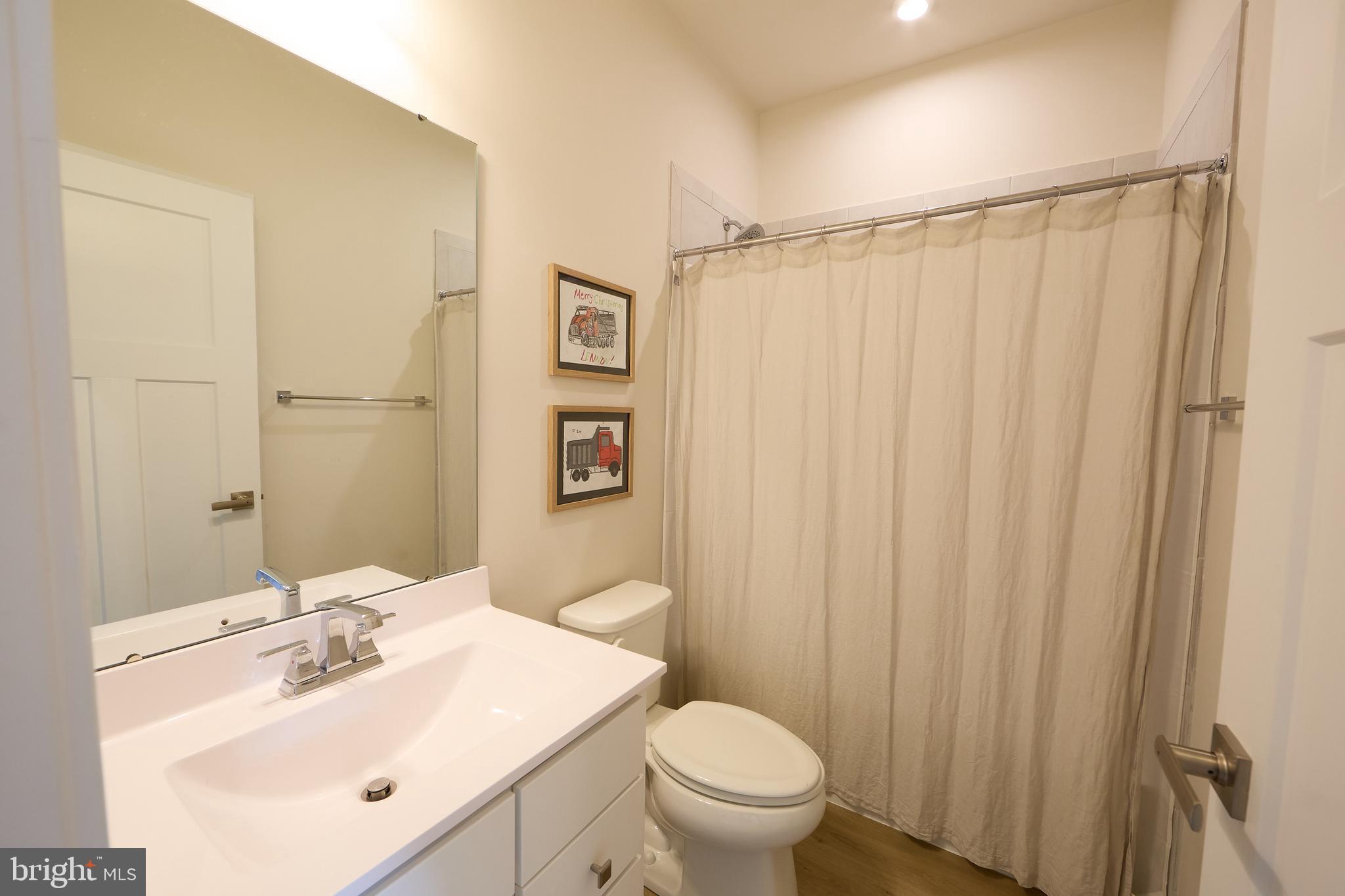 463 Paperbark Square Downingtown, PA 19335 - Photo 22 of 31 a bathroom with a sink a toilet and shower curtain