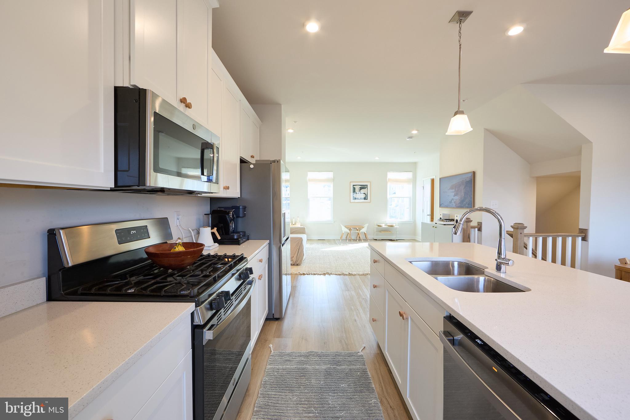 463 Paperbark Square Downingtown, PA 19335 - Photo 3 of 31 a kitchen with stainless steel appliances granite countertop a sink stove and cabinets