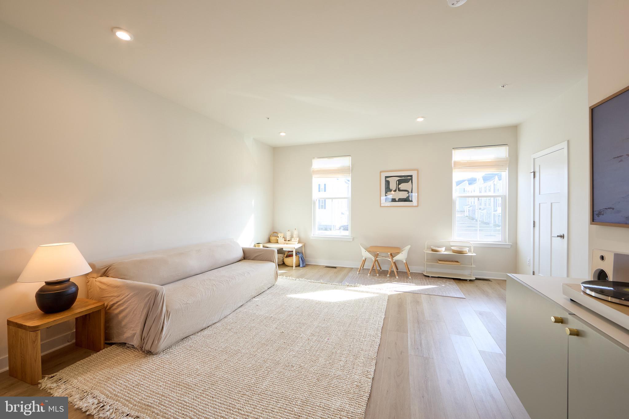 463 Paperbark Square Downingtown, PA 19335 - Photo 6 of 31 a spacious bedroom with a bed a couch and wooden floor