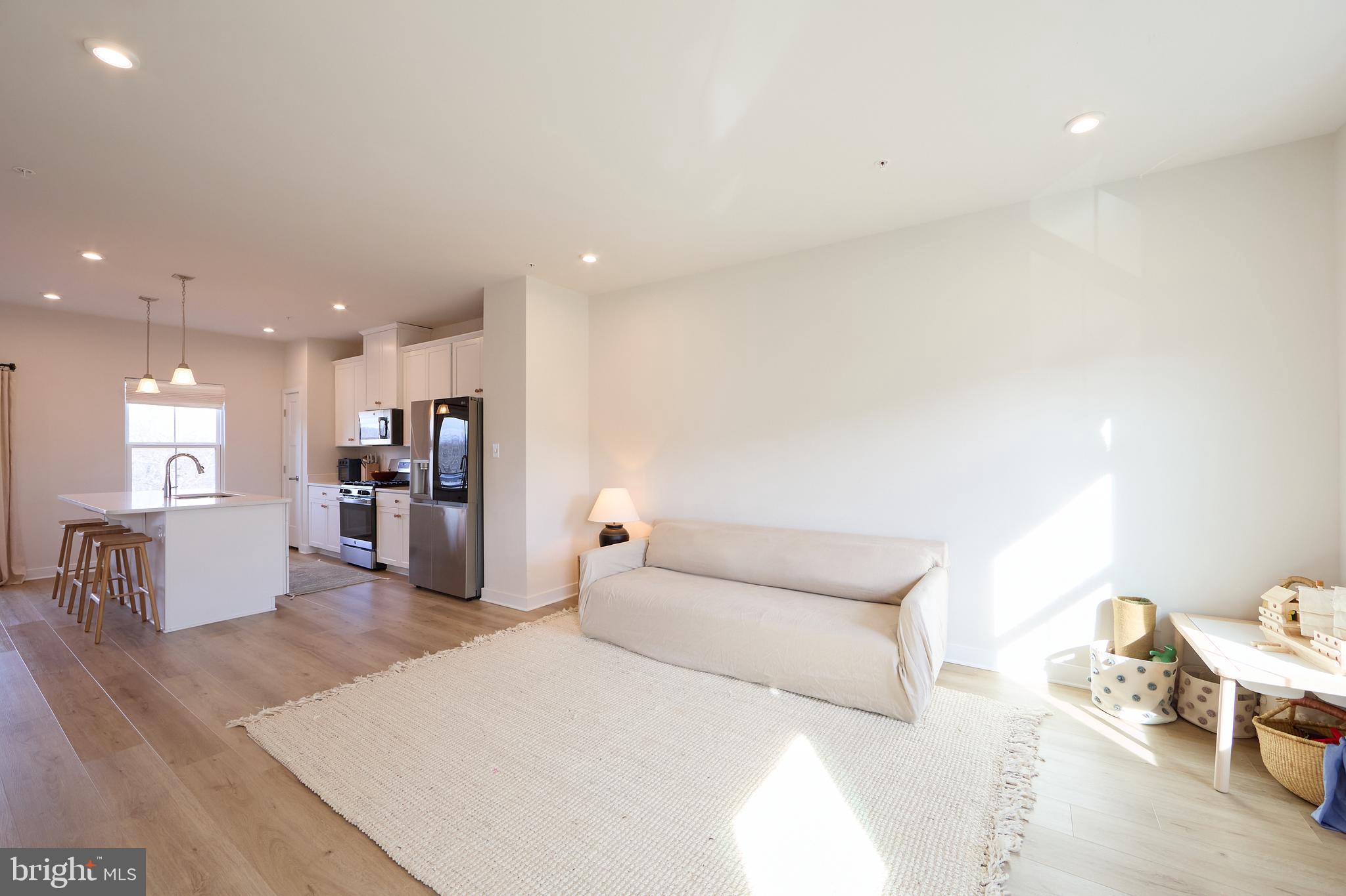 463 Paperbark Square Downingtown, PA 19335 - Photo 9 of 31 a large bedroom with a bed and a view of kitchen