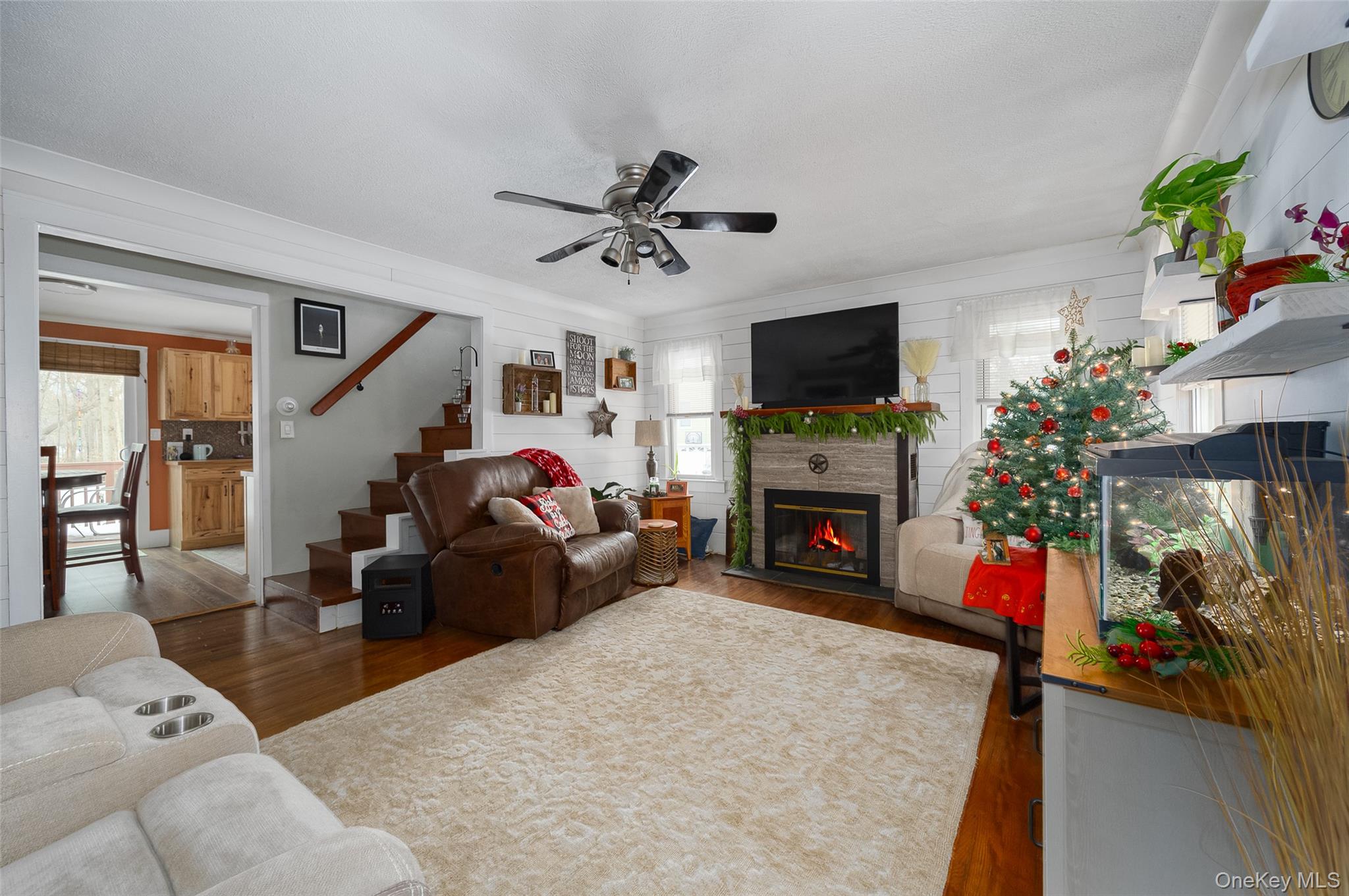 28 Red Oaks Mill Road Poughkeepsie, NY 12603 - Photo 4 of 21 a living room with furniture a flat screen tv and a fireplace