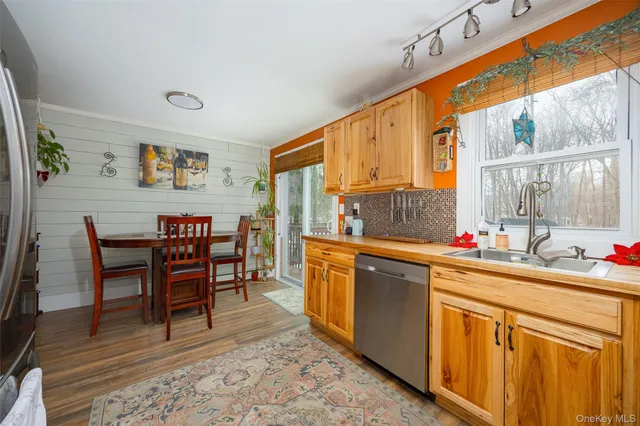 a kitchen with stainless steel appliances a sink and cabinets