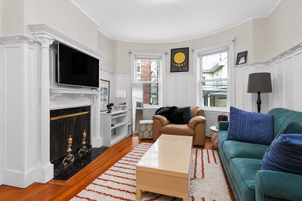 8 Colliston Road Boston, MA 02135 - Photo 2 of 40 a living room with furniture a flat screen tv and a fireplace